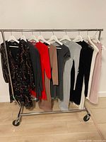 Rack of nine dresses, various colours