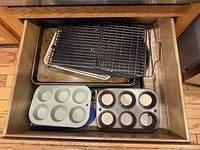 Drawer opened showing all bakeware pieces stacked
