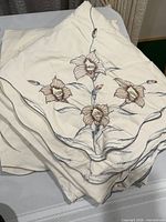Folded tablecloth showing embroidered floral motif