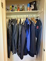 Full closet view showing jackets on rod and shoe care items on shelf