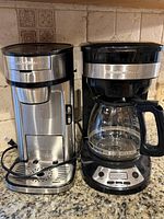 Stainless single-serve and black 12-cup programmable Hamilton Beach coffee makers on countertop