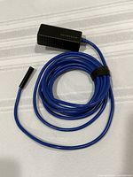 Coiled blue borescope cable with camera probe and WiFi transmitter