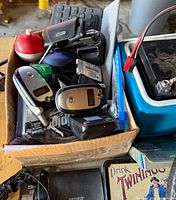 Box with key-fob remotes, chargers, fishing float and batteries