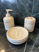 Full view of the three faux marble bathroom pieces on counter