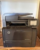 Front/side view of HP LaserJet Pro 400 MFP M425dn showing ADF, touchscreen, HP logo, model badge