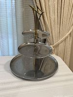 Full view of three-tier chrome serving tray showing all tiers and handle