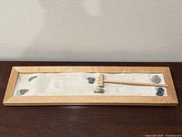 Top view of entire zen garden set showing tray, sand, stones and rake