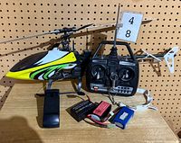 Full view of helicopter, transmitter, batteries and base on table