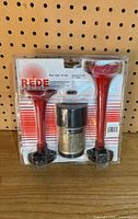 Front of sealed Rede air horn kit showing two red trumpets and compressor