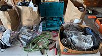 Overall view of lot with Makita jigsaw, jumper cables, wiring and bags