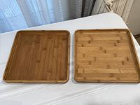 two square wooden platters top view