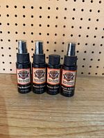 Front view of four Harley-Davidson spray bottles showing labels