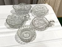 Overview of five cut glass dishes on table