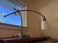 Side view of metal desk lamp on surface