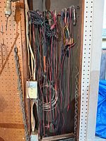 Full view of numerous jumper leads hanging on panel