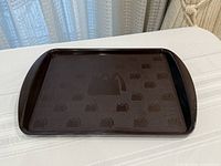 Top view of brown McDonald’s tray showing arches pattern and shape