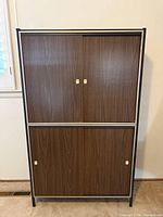 Full view of cabinet front showing both upper and lower sliding doors