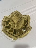 Front view of translucent resin leaf tray showing divided sections and embedded leaves