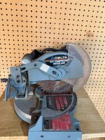 Left front view showing Delta branding, blade guard, angle scale