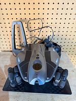 Front view of Rovio robot on dock with beacon and cables