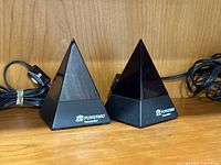 Front view of both Powermid pyramids showing logos and cables