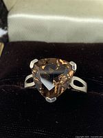 Front view of sterling silver ring displaying trillion smoky quartz