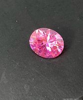 Front angled view of pink oval faceted gemstone