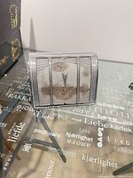 Front view of Pontiac rear speaker housing showing grille and emblem