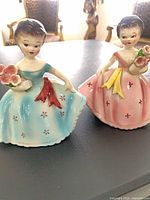 Both Josef Originals figurines side by side