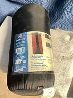 Sleeping bag in black stuff sack