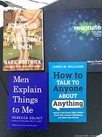 Four books laid out showing covers