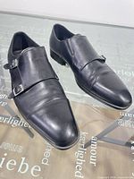 Top view of both shoes showing leather uppers and buckles