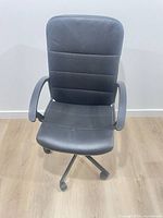 Front view of black adjustable computer chair on casters