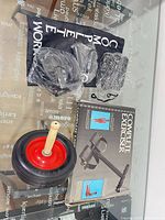 lot overview showing ab roller wheel, boxed exerciser, sealed accessories