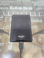 Front view of ADATA HV620 external hard drive with connected cable