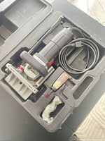 Joiner in case with cord and accessories visible