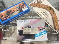 Lot overview showing QuickShot Wizmaster controller box, ring toss game box, boomerang with pouch