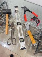 All six hand tools laid out on glass table