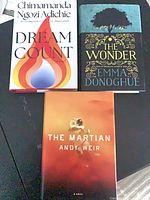 Group shot of all three hardcover novels: Dream Count, The Wonder, The Martian