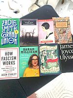 Group shot of all eight softcover books