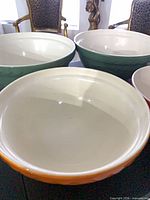 Top view of four Mason Cash bowls showing cream interiors and colours