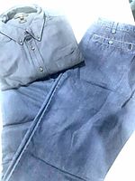 Folded Uniqlo shirt with jeans laid beside