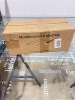 Front view of cardboard carton marked Multifunctional shelf 1P