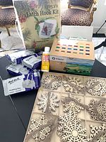 All items group shot showing clay packs, paint set, Mod Podge, latch hook kit box, wooden snowflakes