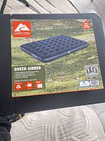 Front of sealed box showing Ozark Trail queen airbed image and specifications