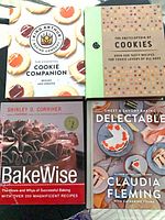 Four hardcover baking cookbooks laid out