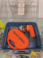 Black & Decker corded drill and bit set inside blue case