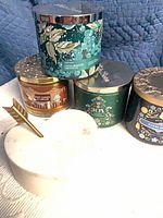 Group of four candles with lids and marble heart box