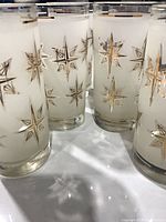 Close-up of several tumblers showing frosted finish and starburst design