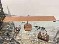 Front view of tan fluorescent desk lamp with Westclox alarm clock